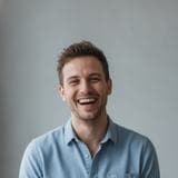 Portrait of a laughing man in a light blue shirt