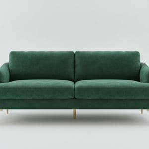 A green velvet sofa on a white studio background