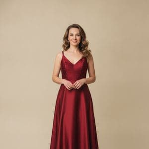A woman in a red evening dress on a plain background