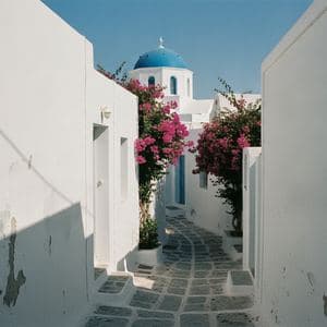 A whitewashed village street with a blue-domed church